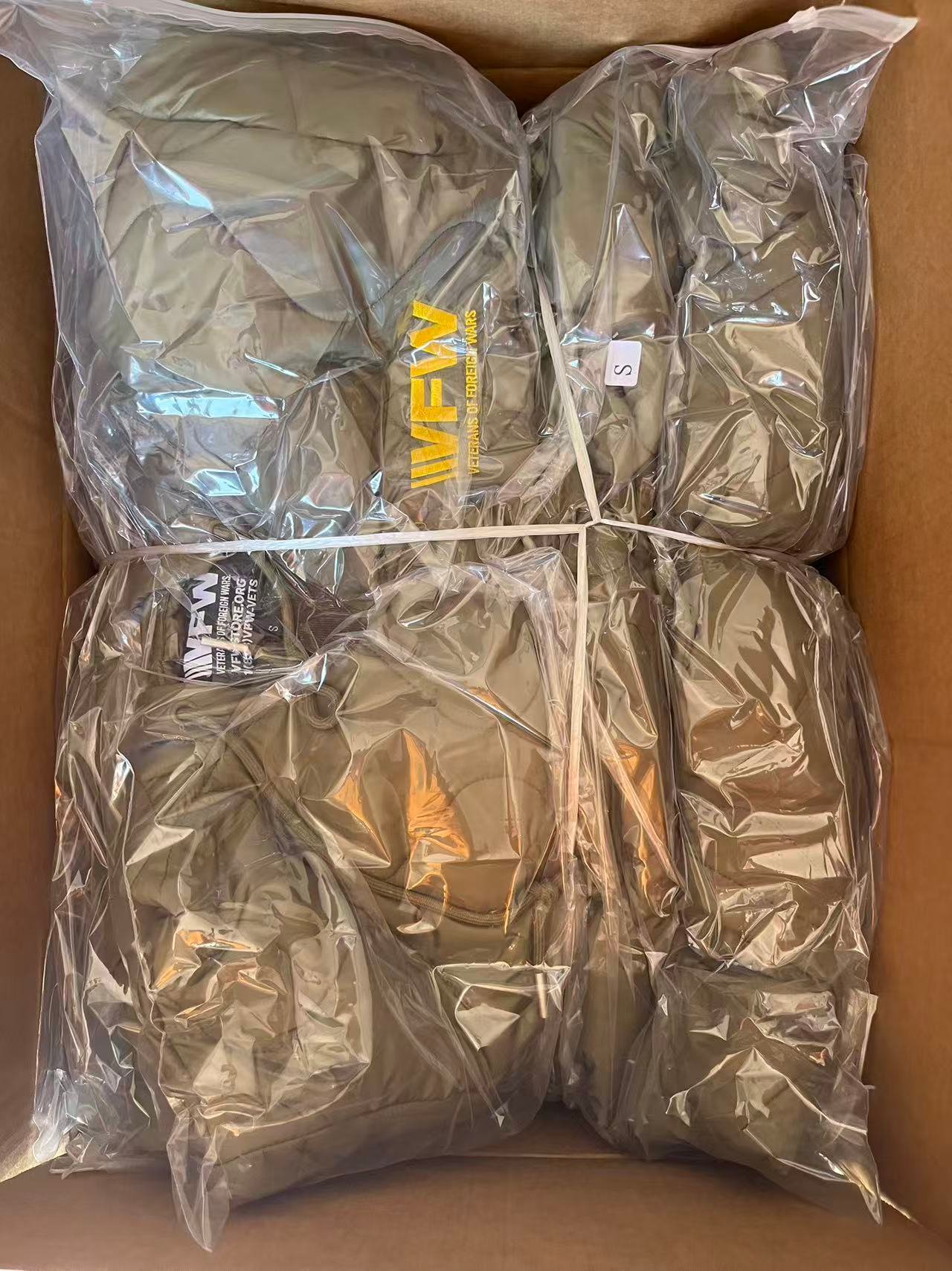 Green hoodie shown as packaged from the factory inside a large ziploc bag.