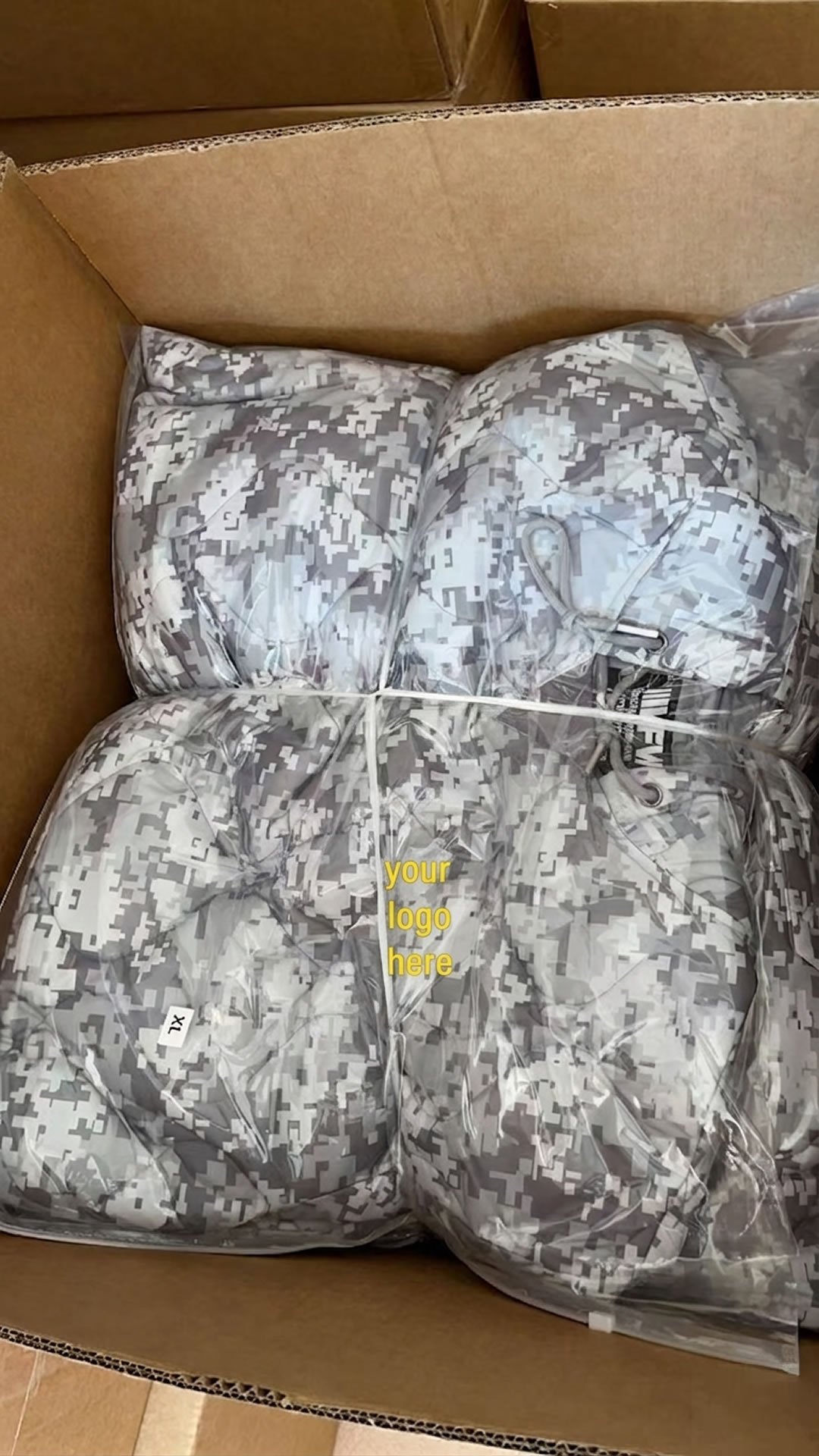 Green hoodie shown as packaged from the factory inside a large ziploc bag.